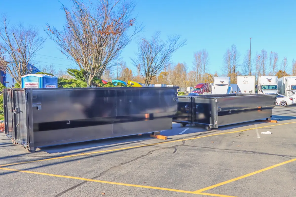 Professional dumpster rental service with roll-off container on residential driveway in Munster